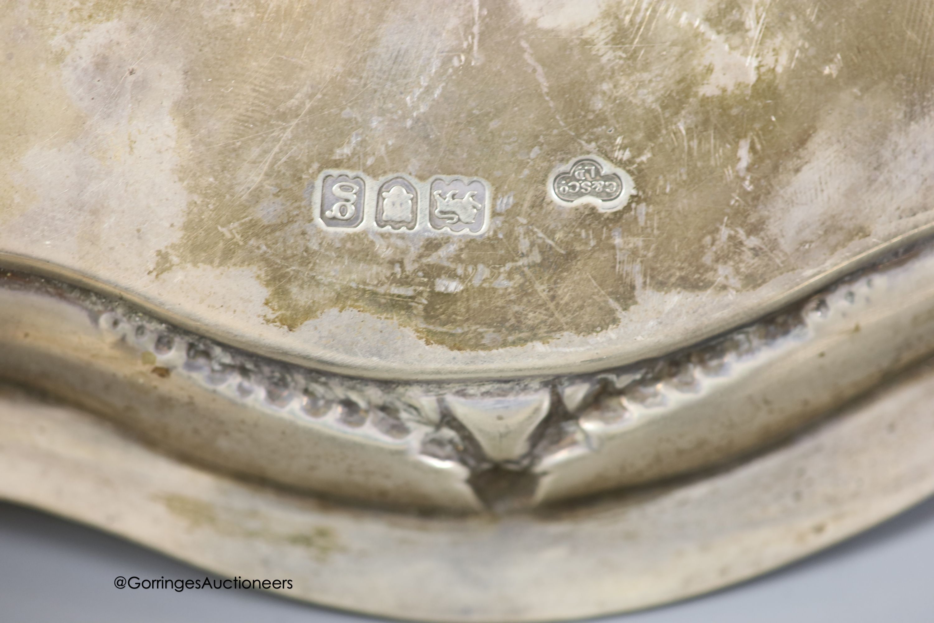 An Edwardian silver shaped circular salver, Goldsmiths & Silversmiths Co Ltd, London, 1902, 25cm and three silver napkin rings
